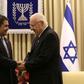 Israeli President Reuven Rivlin (R) shakes hands with Honduran President Juan Orlando Hernandez during a meeting at the presidential compound in Jerusalem, on October 29, 2015