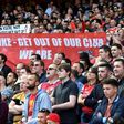 Arsenal fans hold up a banner against majority owner Stan Kroenke during an English Premier League football match at the Emirates Stadium in London on May 21, 2017