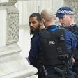 Firearms officers from the British police detain a man on Whitehall near the Houses of Parliament in central London on April 27, 2017