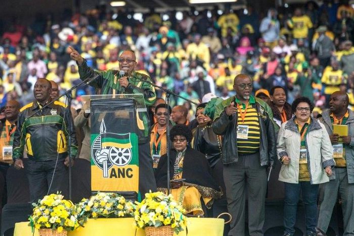 South African President Jacob Zuma delivers a speech on stage at Orlando Stadium in Soweto on January 8, 2017