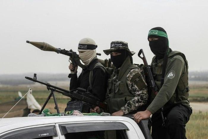 Members of the Ezzedine al-Qassam Brigades, the militant wing of the Palestinian Islamist movement Hamas, patrol in the southern Gaza Strip