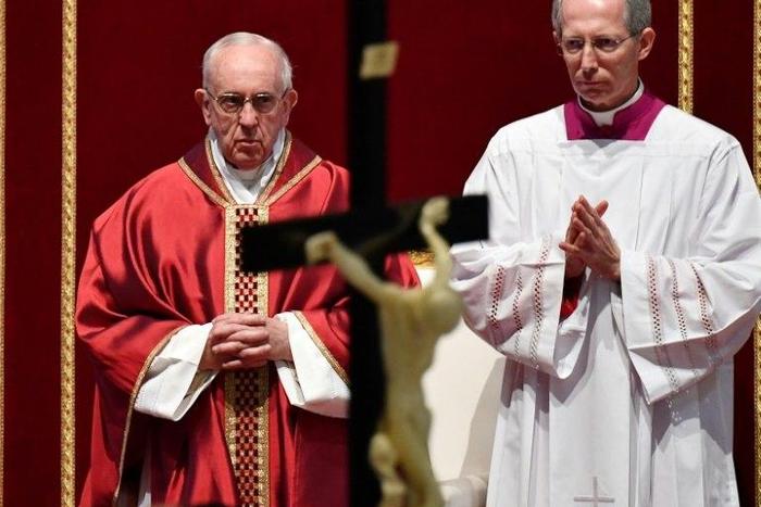 Pope Francis (L) presides over the Celebration of the Lord's Passion on Good Friday at St Peter's basilica, on April 14, 2017 in Vatican