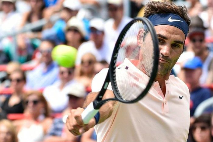 Roger Federer of Switzerland hits a return shot against Peter Polansky of Canada during day six of the Rogers Cup in Montreal, Canada