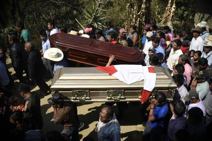 Thousands of indigenous Guatemalans accompany to the cemetery the coffins of two children killed by their kidnappers in the Cerro Alto village in San Juan Sacatepequez, 45km west of Guatemala city on February 14, 2017