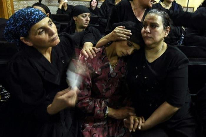 Relatives of killed Coptic Christians grieve during a funeral at Abu Garnous Cathedral in the north Minya town of Maghagha, on May 26, 2017
