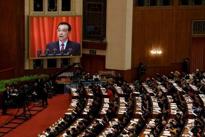 Chinese Premier Li Keqiang announces a trimmed 2017 GDP growth target of around 6.5 percent