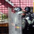 Venezuelan national guard officers in riot gear protect themselves during Friday's protest against President Nicolas Maduro's government
