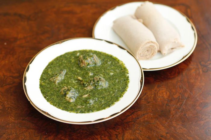 Molokhia cooked in lamb meat, ready to eat, with Injera.