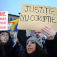 A woman holds a placard reading "Justice not Corruption" during a protest against government corruption in Bucharest January 22, 2017