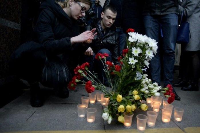 People place flowers and lit candles in memory of victims of the blast in the Saint Petersburg metro outside Sennaya Square station on April 3, 2017