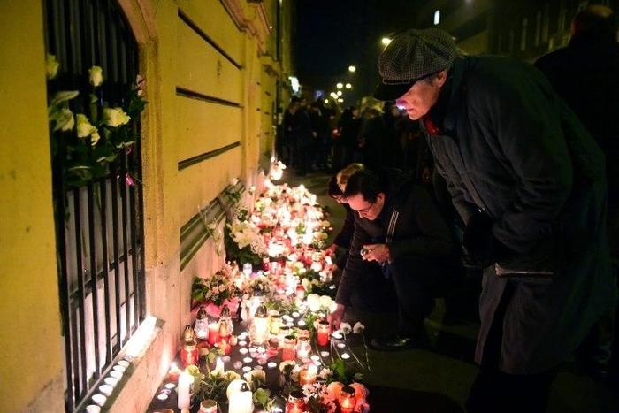 Mourners leave flowers and candles at a memorial in Budapest on January 22, 2017 for the victims of Friday's deadly coach crash in Italy