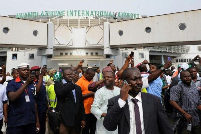 People wait for relatives at Nnamdi Azikiwe International Airport in Abuja, Nigeria