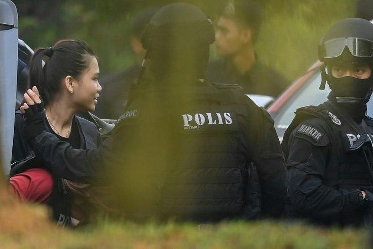Indonesian national Siti Aisyah, one of the two acused, is taken into court with a Malaysian police escort