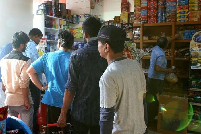 People buy snacks at a shop in Qatari capital Doha on June 5, 2017 as the gas-rich Gulf state grappled with a diplomatic crisis after its neighbours cut ties