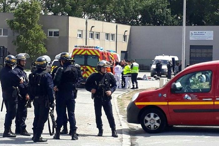 Police officers and emergency workers intervene after clashes between African migrants in what officials say is escalating violence in the northern French port of Calais