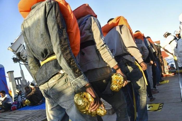 Rescued migrants and refugees wait to be transferred in 2016