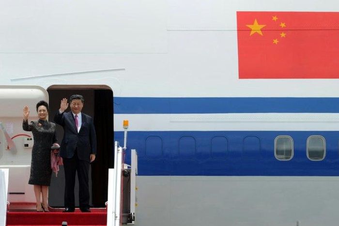 China's President Xi Jinping and his wife Peng Liyuan wave as they depart from Hong Kong's international airport, on July 1, 2017