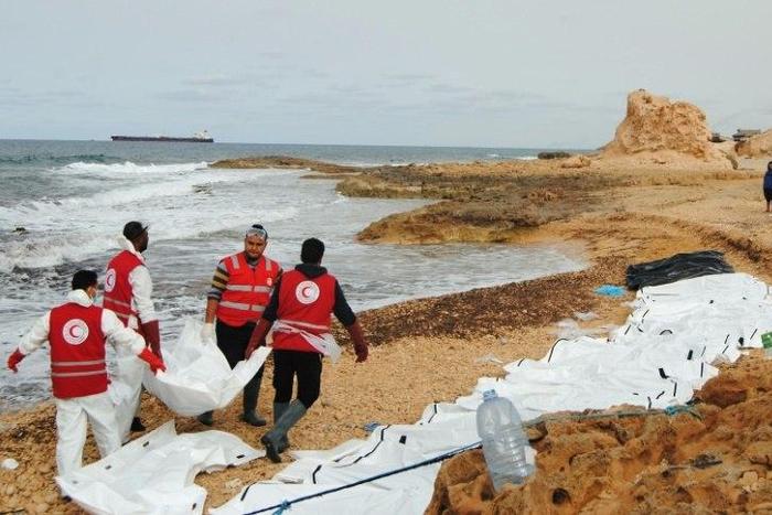 Libyan Red Crescent volunteers recovering the bodies of 74 migrants that washed ashore on February 20 near Zawiyah on Libya’s northern coast on February 21, 2017