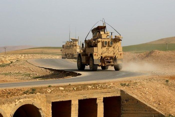 US-made armoured vehicles bearing markings of the US Marine Corps on a road north of Raqa in northern Syria as clashes region in the area between US-backed forces and Islamic State group jihadists