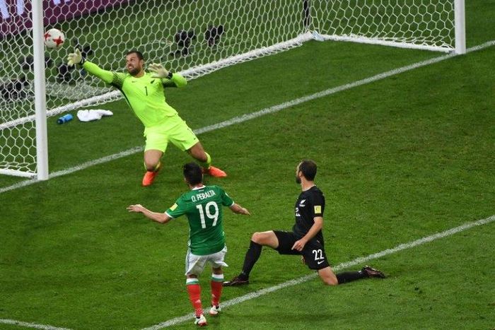 Mexico's forward Oribe Peralta (C) scores a goal past New Zealand's goalkeeper Stefan Marinovic (back) during the 2017 Confederations Cup group A football match June 21, 2017