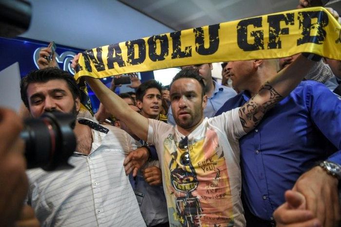French football player Mathieu Valbuena (C) is greeted by fans as he arrives at Ataturk International airport in Istanbul, Turkey in June