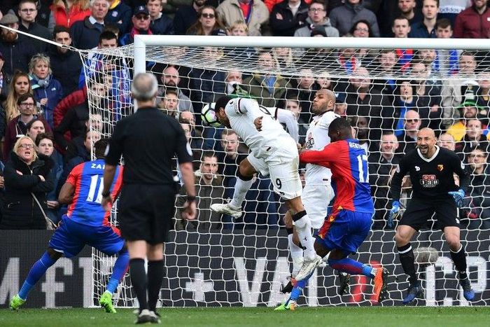 Watford's striker Troy Deeney (C) scores an own goal during the English Premier League football match against Crystal Palace March 18, 2017