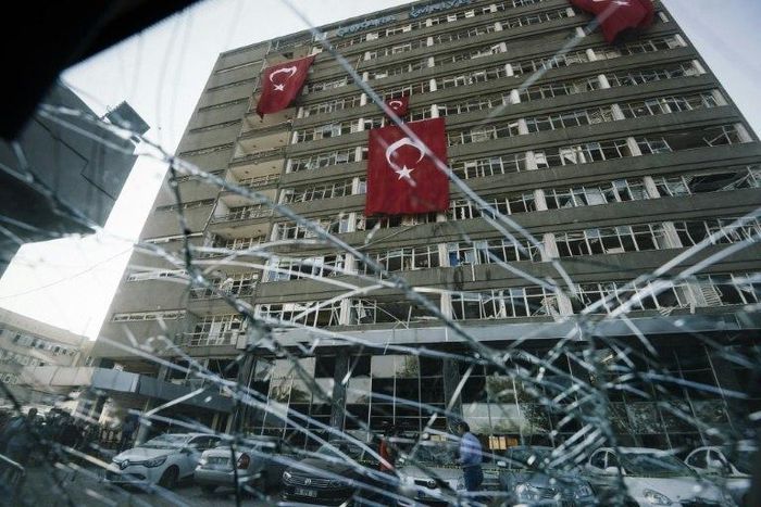Turkish flags hang from the facade of the damaged Ankara police headquarters after it was bombed during the failed July 15 coup attempt, in a picture taken on July 19, 2016
