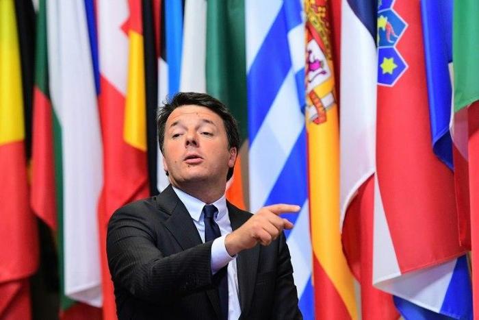 Italian Prime Minister Matteo Renzi points a finger as he leaves the European Union leaders summit on October 21, 2016 at the European Council, in Brussels