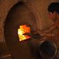 A Cambodian labourer stokes a kiln at a brick factory on the outskirts of Phnom Penh