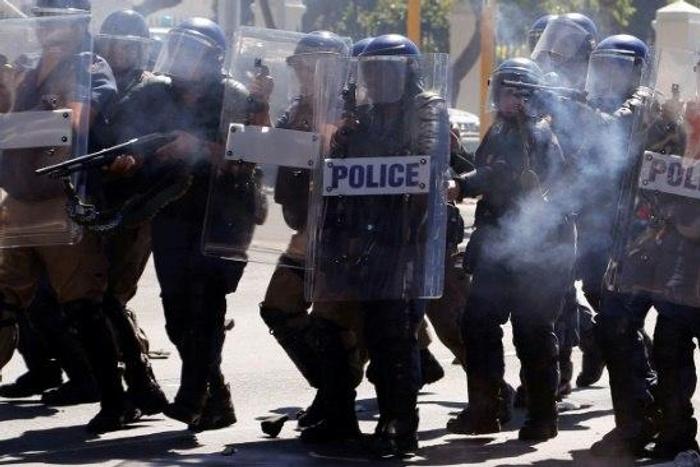 South African Police attend a protest outside Parliament in Cape Town