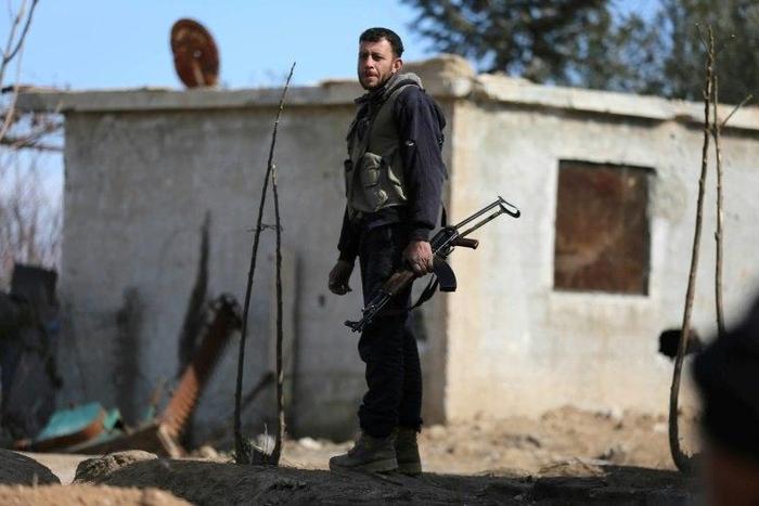 A fighter from Jaish al-Islam (Islam Army) rebel group stands guard in Bilaliyah, east Damascus, earlier this month