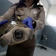 An Indonesian customs officer displays a reptile after authorities arrested a suspected wildlife smuggler from Japan