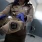 An Indonesian customs officer displays a reptile after authorities arrested a suspected wildlife smuggler from Japan