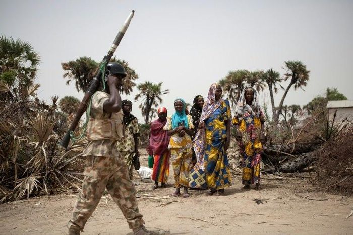 A Nigerian soldier patrols on the outskirts of Damasak in northeastern Nigeria as peace returns after years of trouble from Boko Haram insurgents
