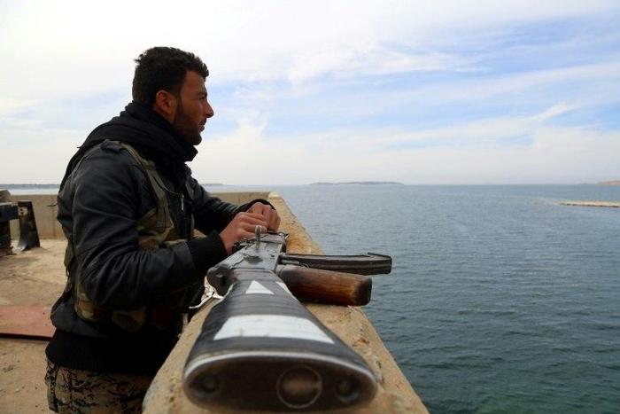 A member of the US-backed Syrian Democratic Forces (SDF), an alliance of Arab and Kurdish fighters, inspect the Tabqa dam on March 27, 2017