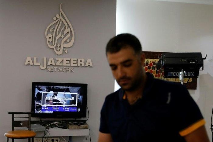 An employee of Qatar-based Al-Jazeera at the broadcaster's Jerusalem office on July 31, 2017