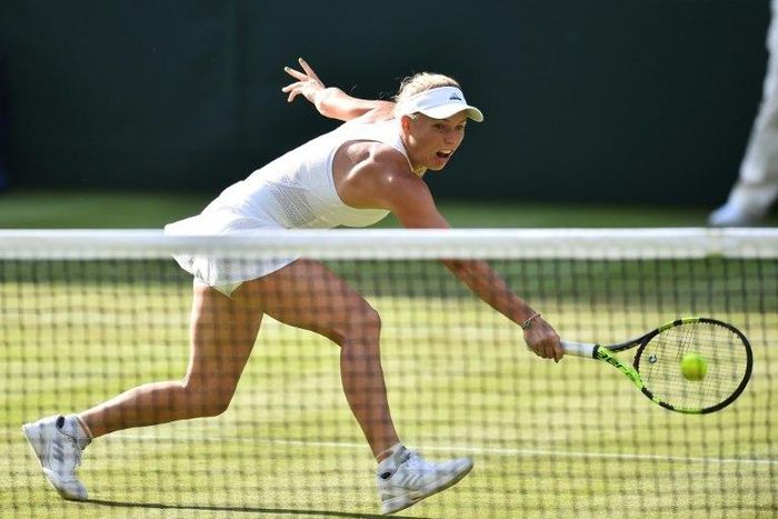 Denmark's Caroline Wozniacki returns against Hungary's Timea Babos during their women's singles first round match on the second day of the 2017 Wimbledon Championships July 4, 2017