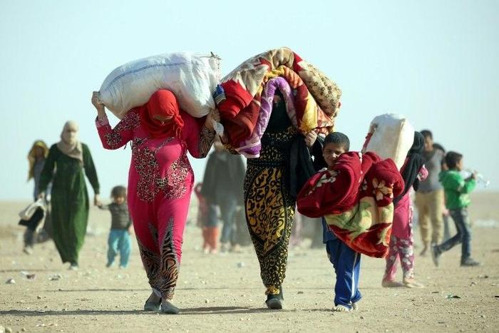 Refugees who fled Mosul, the last major Iraqi city under the control of IS group, arrive in the desert area of Rajm al-Salibeh on the Iraq-Syria border south of al-Hol in Syria's Hassakeh province on October 22, 2016