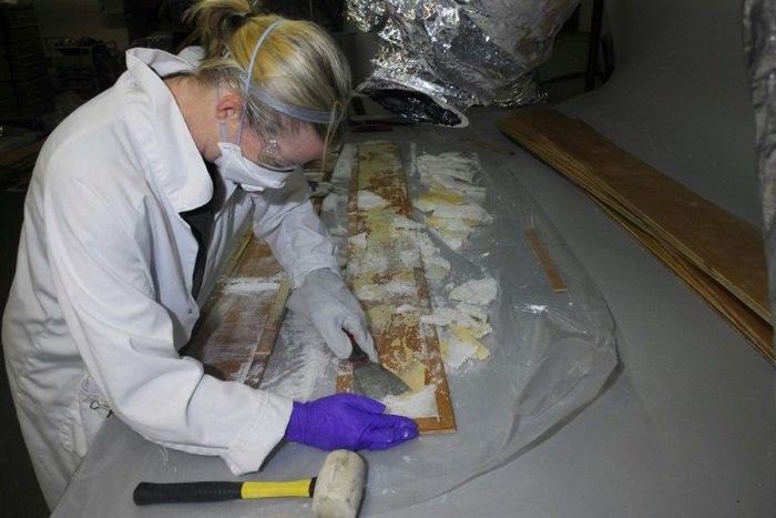 Crystal methamphetamine is removed from planks of wood at a warehouse in Nunawading, east of Melbourne, Australia, where it was hidden in 70 boxes of floorboards shipped from China