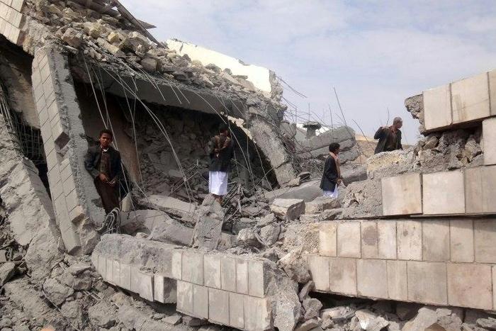A Yemeni boy stands on the rubble of a school destroyed by a Saudi-led air strike on the outskirt of the northwestern Saada province