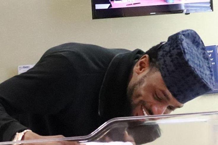 A happy D'banj smiles at his new born child, Daniel.