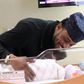 A happy D'banj smiles at his new born child, Daniel.