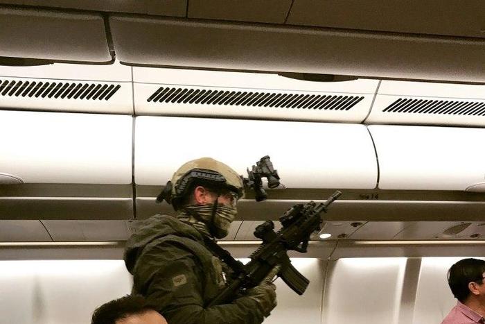 Armed police boarded a Malaysia Airlines flight which was forced to return to Melbourne after a passenger tried to enter the cockpit claiming he had a bomb