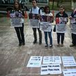 Relatives of passengers missing on Malaysia Airlines MH370 hold placards after a joint press conference of the Ministerial Tripartite Meeting on the search for the missing flight outside Kuala Lumpur on July 22, 2016