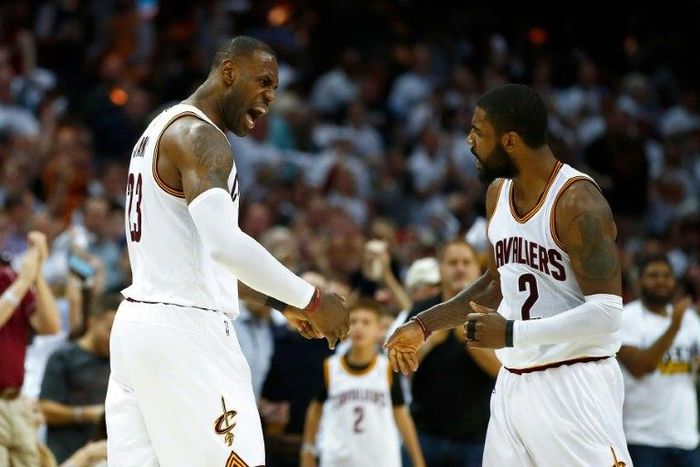 LeBron James (L) of the Cleveland Cavaliers celebrates a dunk with teammate Kyrie Irving, at Quicken Loans Arena in Cleveland, Ohio, on April 15, 2017