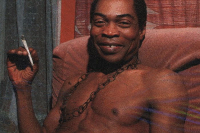 Fela, joint in hand, smiles for the camera during an interview at his home, Kalakuta Republic