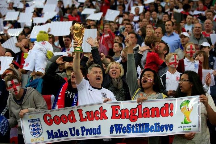 England fans cheer for their team during the international friendly football match between England and Peru at Wembley Stadium in north London on May 30, 2014