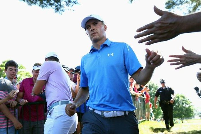 Jordan Spieth of the US high-fives fans after putting on the ninth green during the first round of the Travelers Championship, at TPC River Highlands in Cromwell, Connecticut, on June 22, 2017