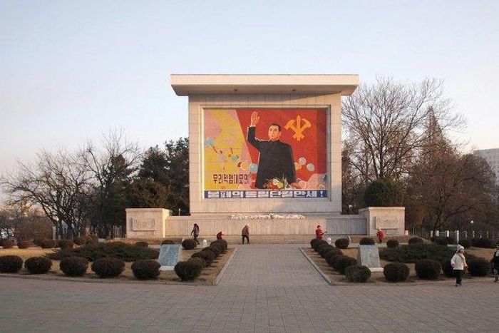 People clean a monument featuring North Korea's founding father Kim Il-Sung in central Pyongyang. The tour agency that took US student Otto Warmbier to Pyongyang says it will stop taking Americans to the reclusive state