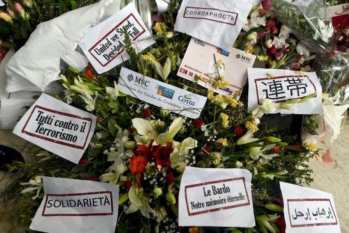 Flowers and messages of condolences are laid outside Tunisia's Bardo National Museum on March 24, 2015 in Tunis, six days after it witnessed an attack which killed 21 people